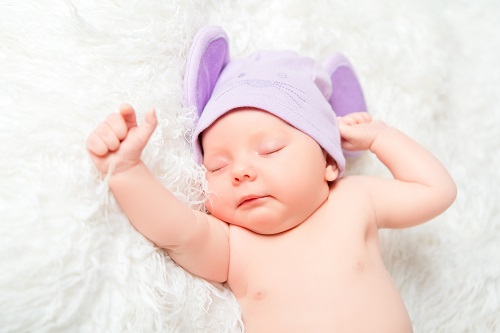 cute newborn baby sleeps in a hat with ears