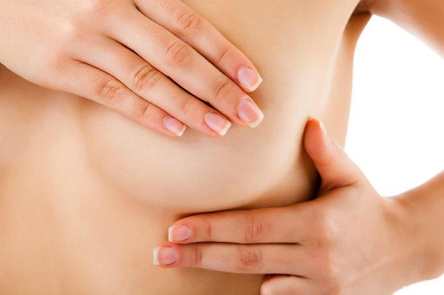 Mulher massageando os seios