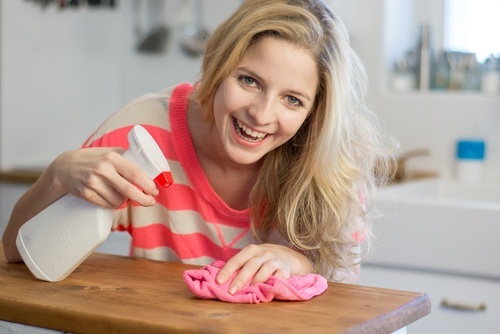 Mulher removendo o mofo com água oxigenada