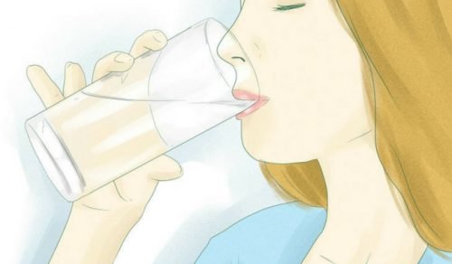Mulher bebendo água morna