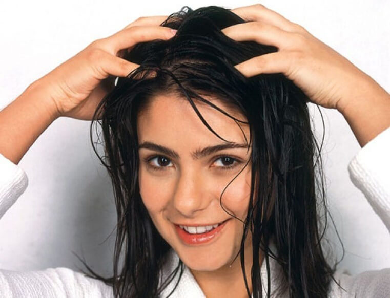 Mulher massageando couro cabeludo