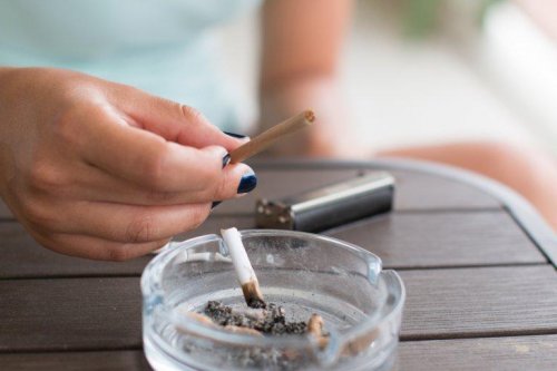 Pessoa com cigarro na mão