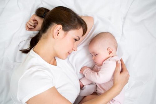 Mãe olhando o bebê dormir