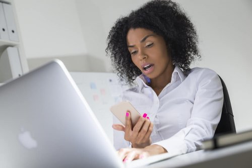 Mulher surpresa com notícia no celular